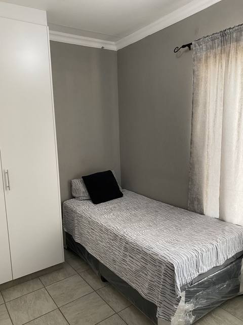 Furnished bedroom with built-in wardrobe